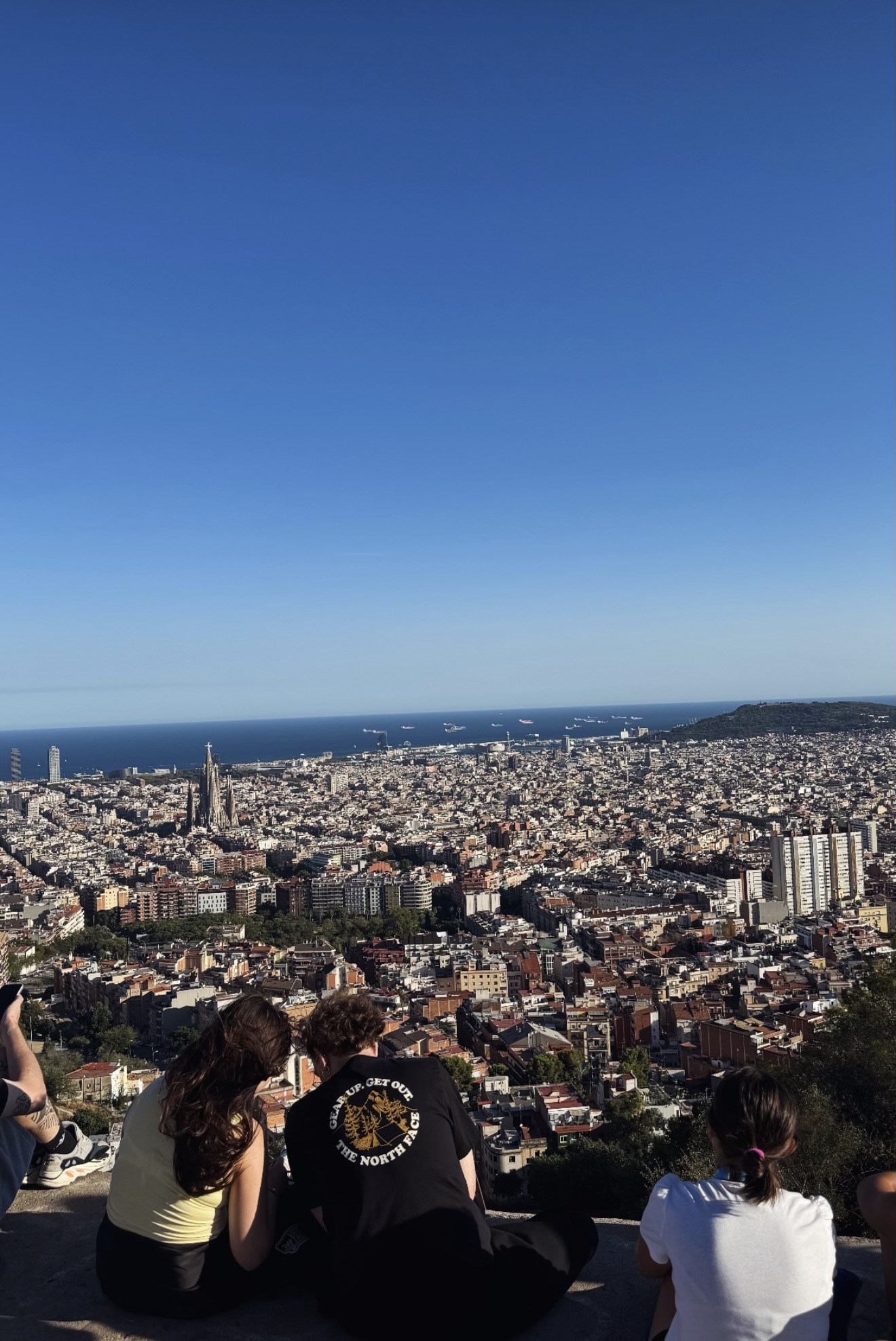 Travellers looking out over Barcelona from Bunkers del Carmel