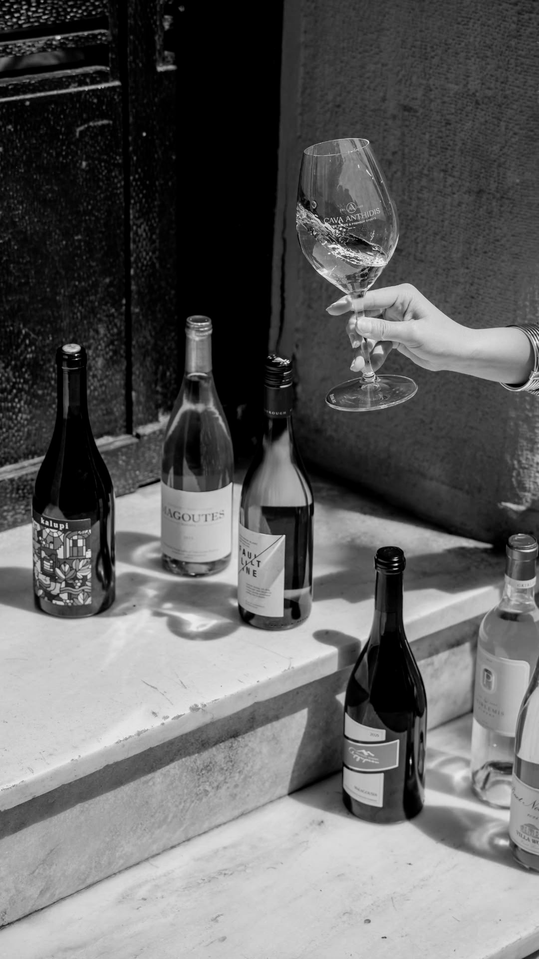 Wine bottles lined up for a tasting